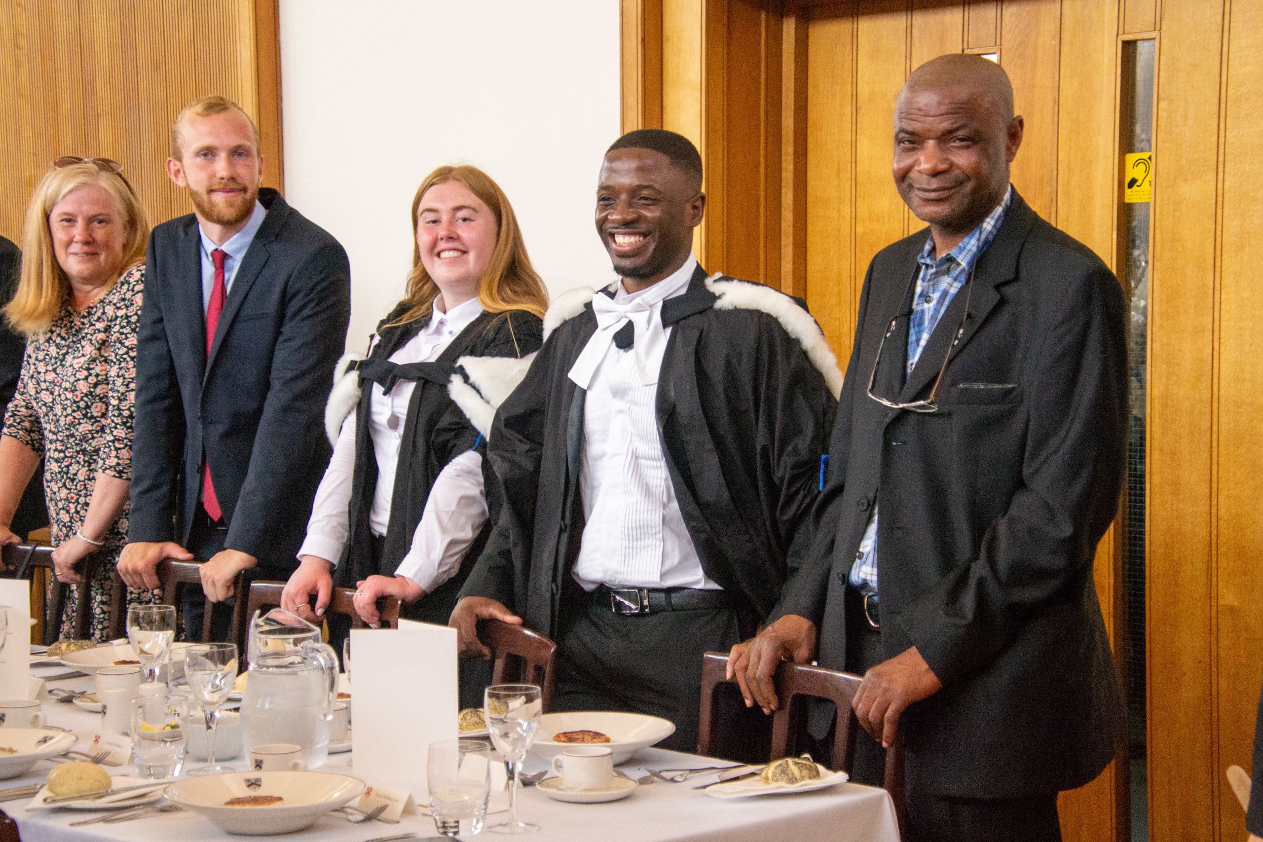 Students and family attending a dining event in the hall.